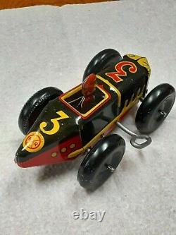 Vintage black, yellow, & red #3 tin wind-up race car by Marx circa 1945 used